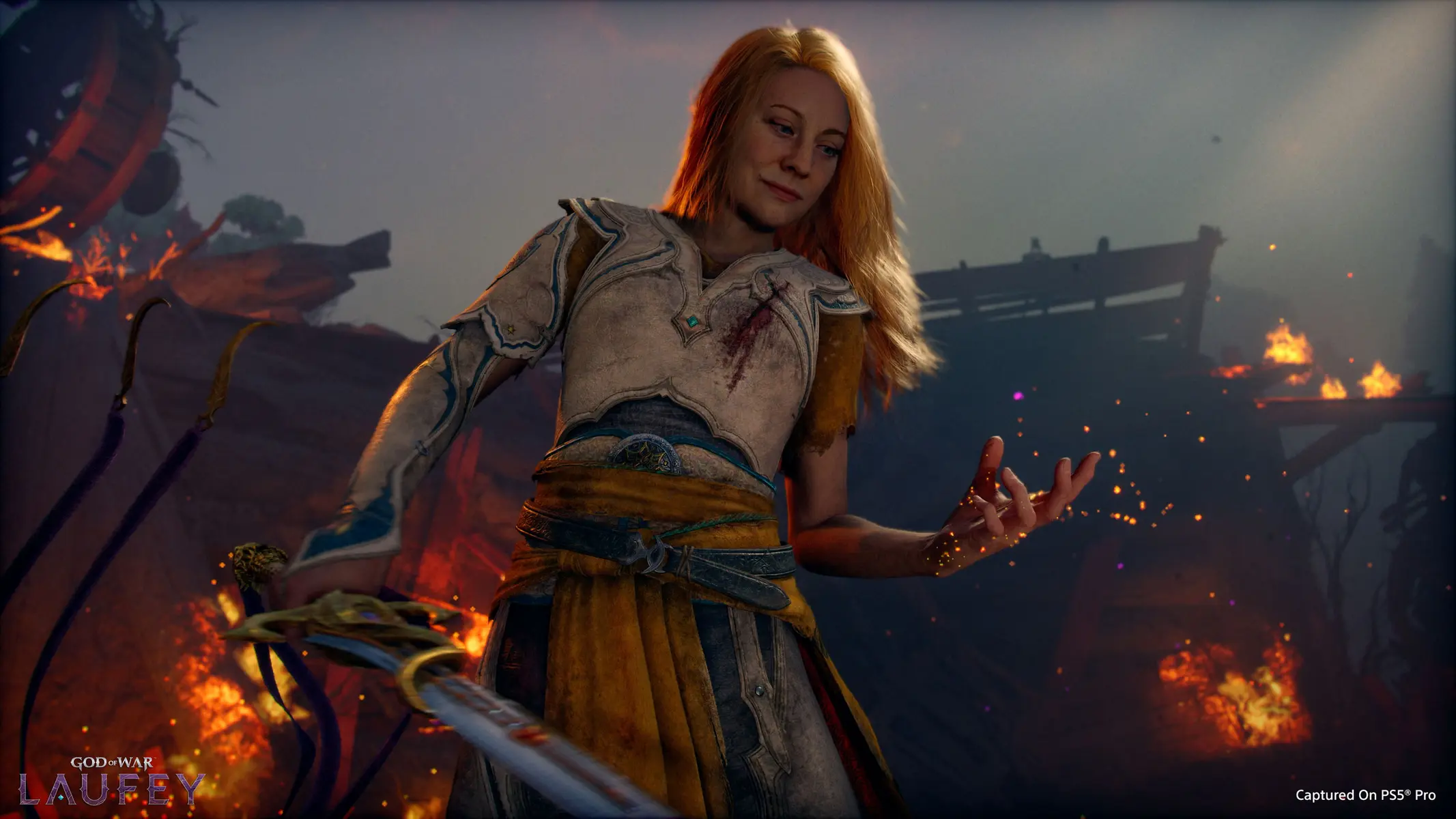 Official character artwork of Laufey from God of War, wearing white and gold armor amidst a battlefield of fire.
