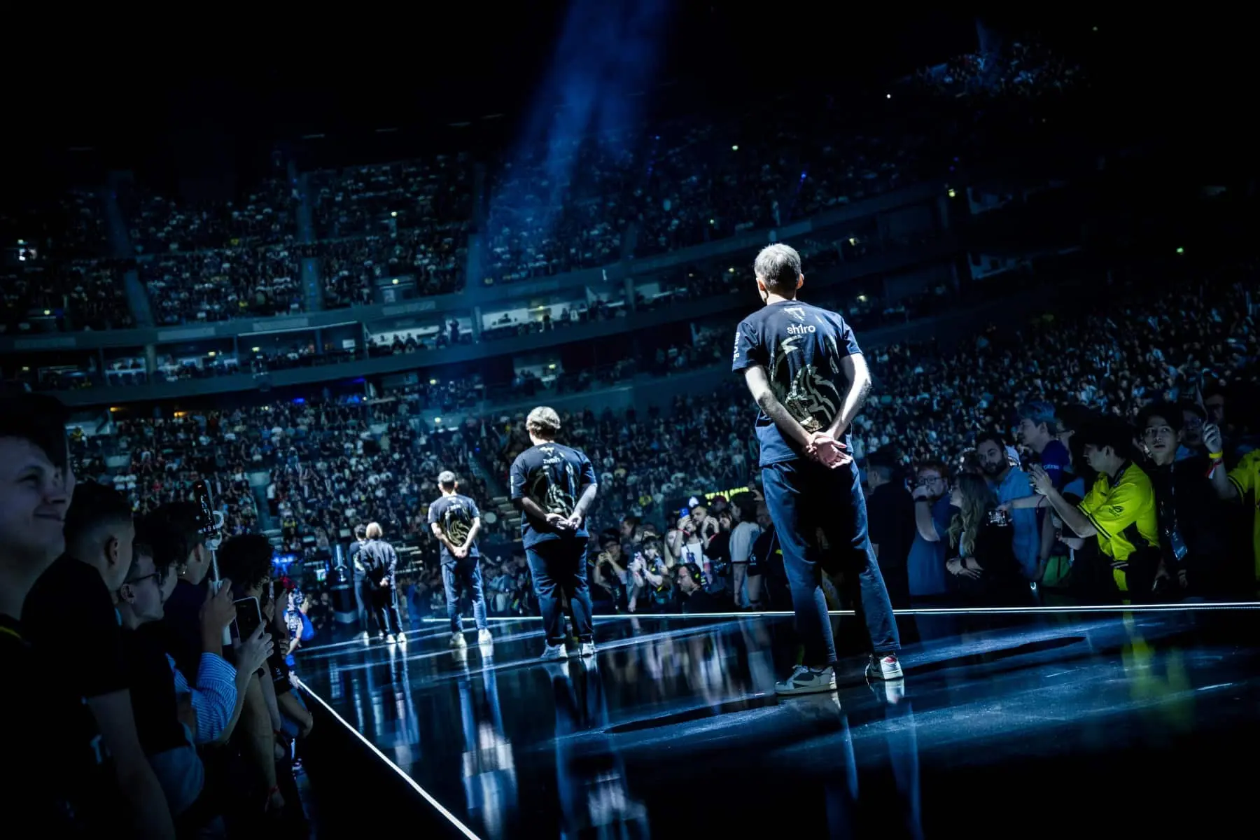 Team Spirit CS2 players standing on a stage facing a cheering crowd in a large arena