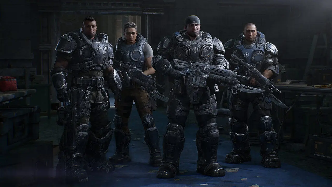 Four Gears of War: E-Day soldiers in heavy combat armor holding futuristic weapons in a military base