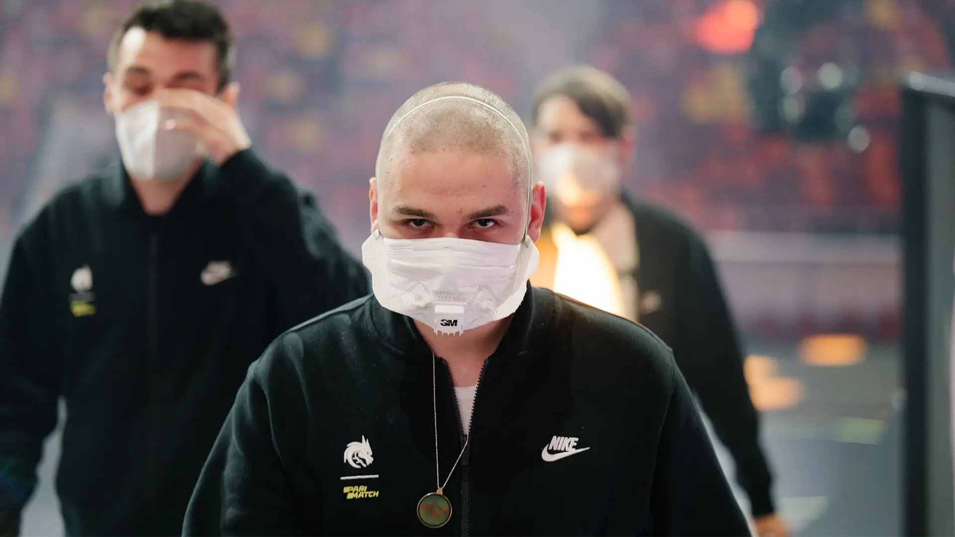 Yatoro of Team Spirit wearing a black Nike jacket and a white face mask